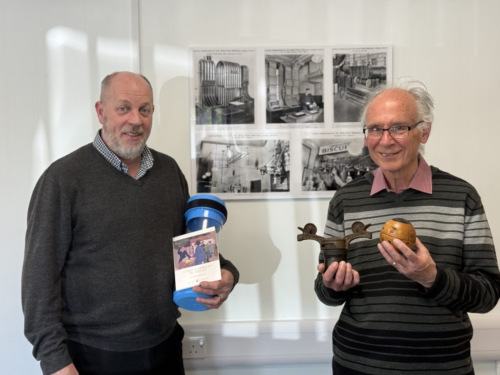 Andrew Buxton and Quirepace team member at Quirepace HQ during a visit exploring historic pneumatic cash carrier systems